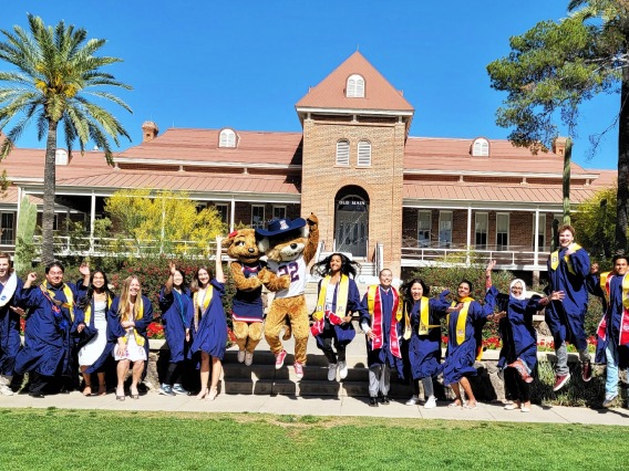 Class of 2023 group photo while jumping with Wilbur and Wilma