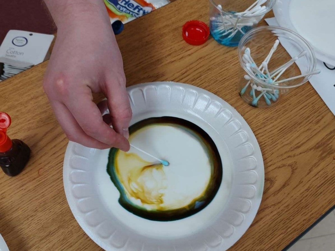 Disposable plate with detergent, milk, and color dye