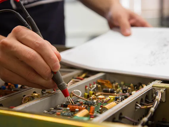 Electronics Shop testing a board