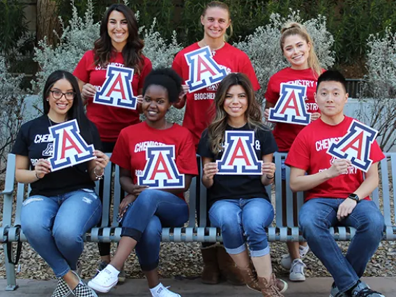 Happy CBC students sitting on a bench