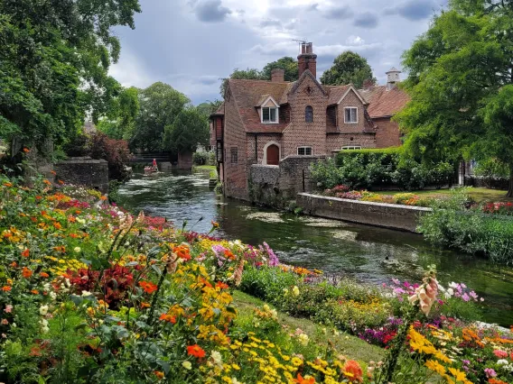 Photo of large brick house by a river taken by Ananya Chakraborti