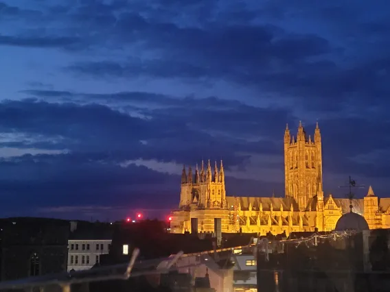 Photo of night sky and large castle glowing from outer lights, taken by Ananya Chakraborti