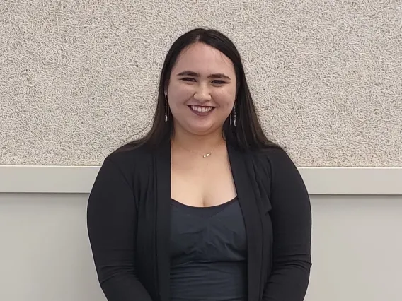 Lilia Alexis Koelemay smiling towards the camera, wearing black.