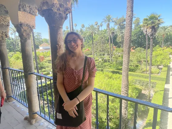 Olivia Seagraves in Spain smiling towards the camera, wearing a dress