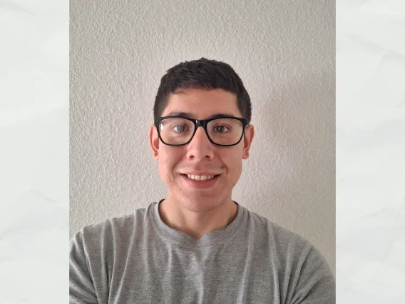 Christian Viramontes wearing a gray shirt smiling towards the camera