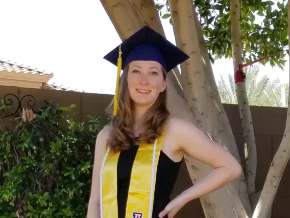 Photo of Ashley Wellington in graduation cap and gown