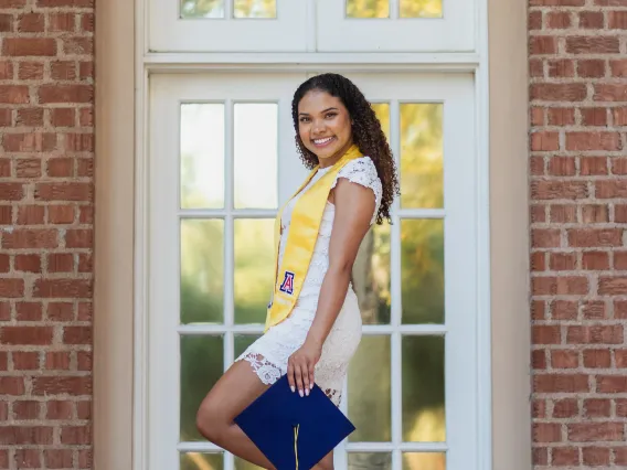 Marie Ojeh holding graduation cap