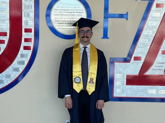 Michael Foster wearing a graduation cap and gown