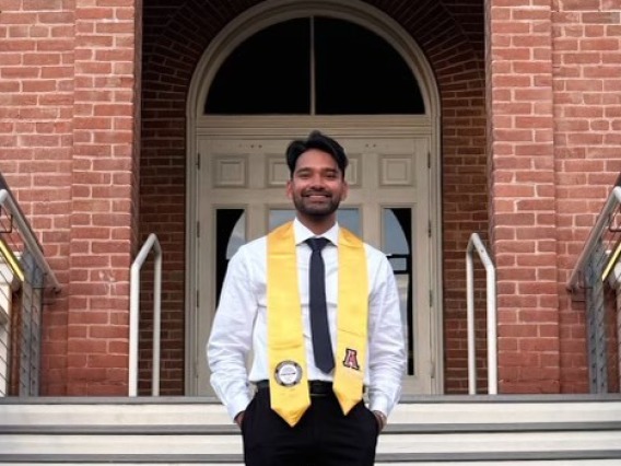 Neel Ahmed standing in front of University of Arizona Old Main Building