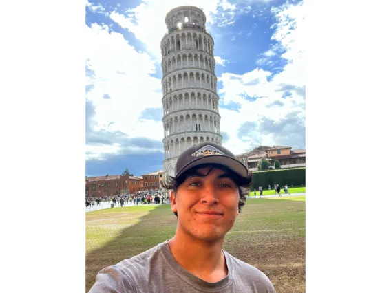 Maximo Mondragon standing in front of Leaning Tower of Pisa