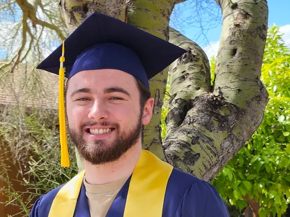 Skyler Tilden wearing graduation cap and gown