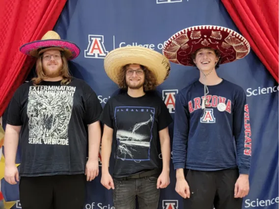 3 students wearing mariachi hats