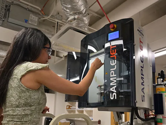 Student loading a sample into the NMR