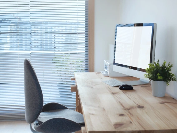 Desk, table, and chair. With a monitor and plant on the desk