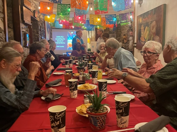 Dinner table with people on both sides of a rectangle table at Charro Cafe