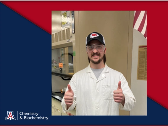 Photo of Hayden Leatherwood thumbs up in lab coat and safety goggles