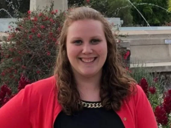 Holly Sofka smiling in front of old main water fountain