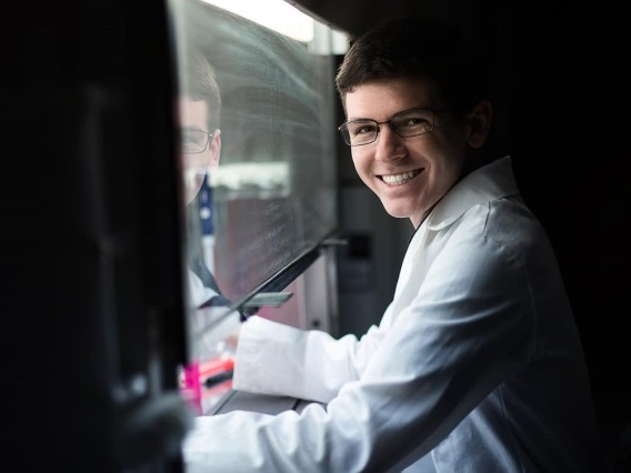 photo of student Jason Kronenfeld in a lab smiling