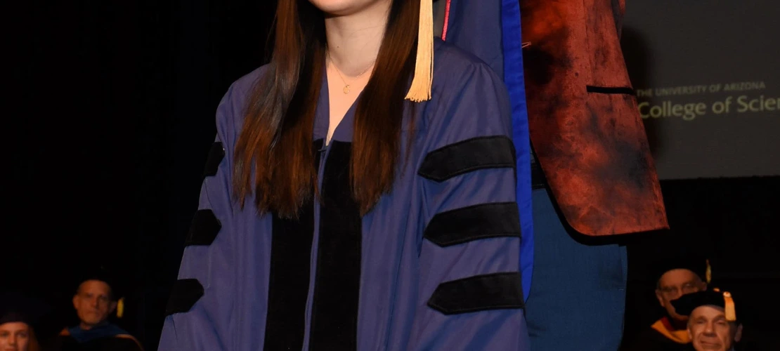Beverly Feng presented with a PhD graduation garment by Dr. Andrei Sanov