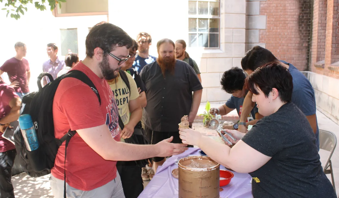 Photo of person handing another person ice cream on a cone