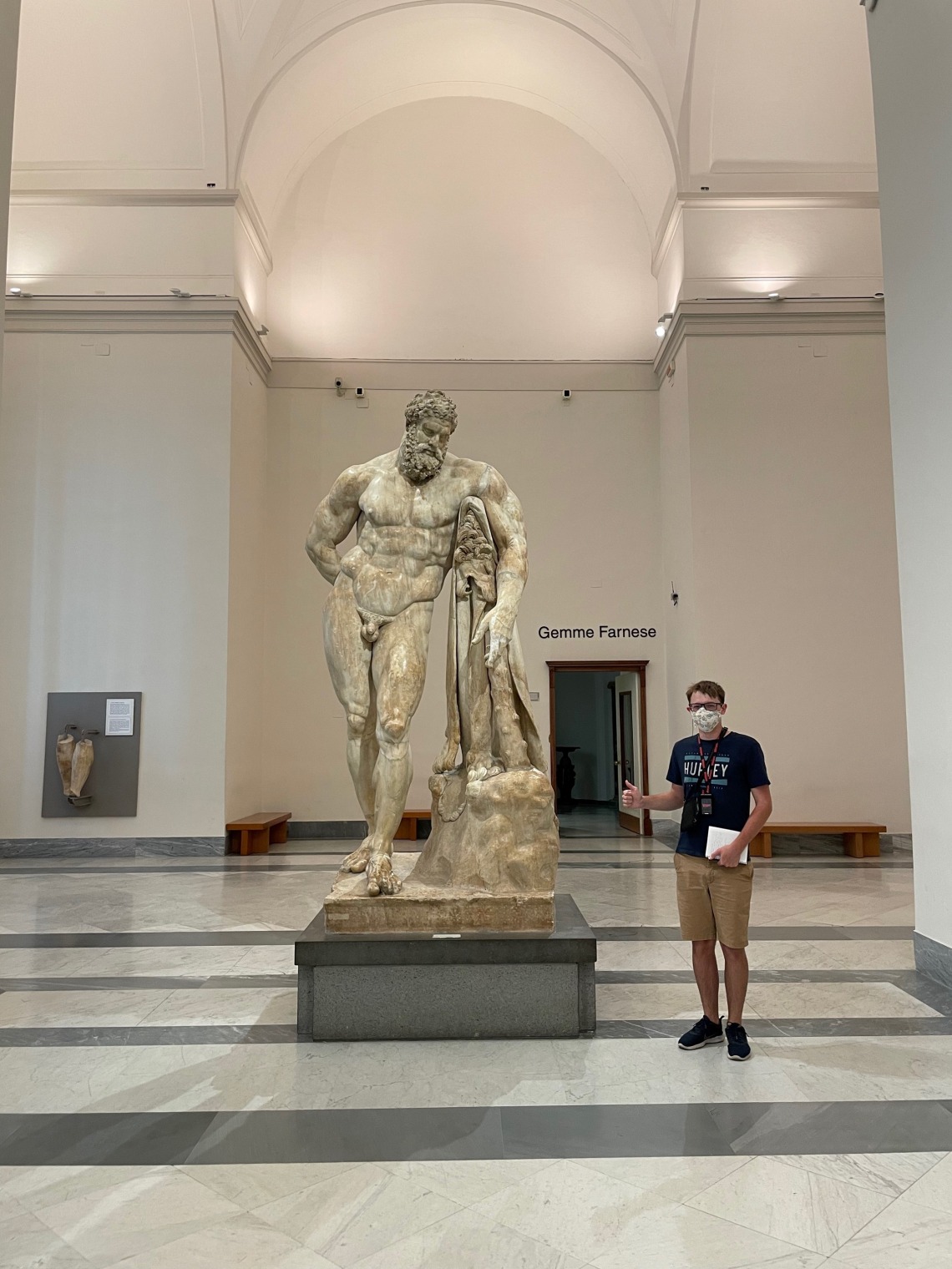 Caleb standing next to a statue