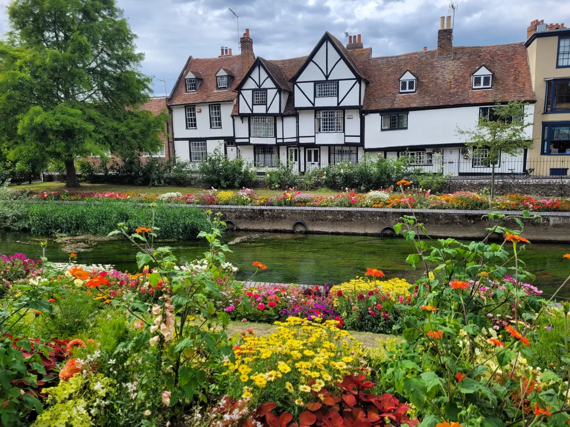 Photo of large white house by a river taken by Ananya Chakraborti