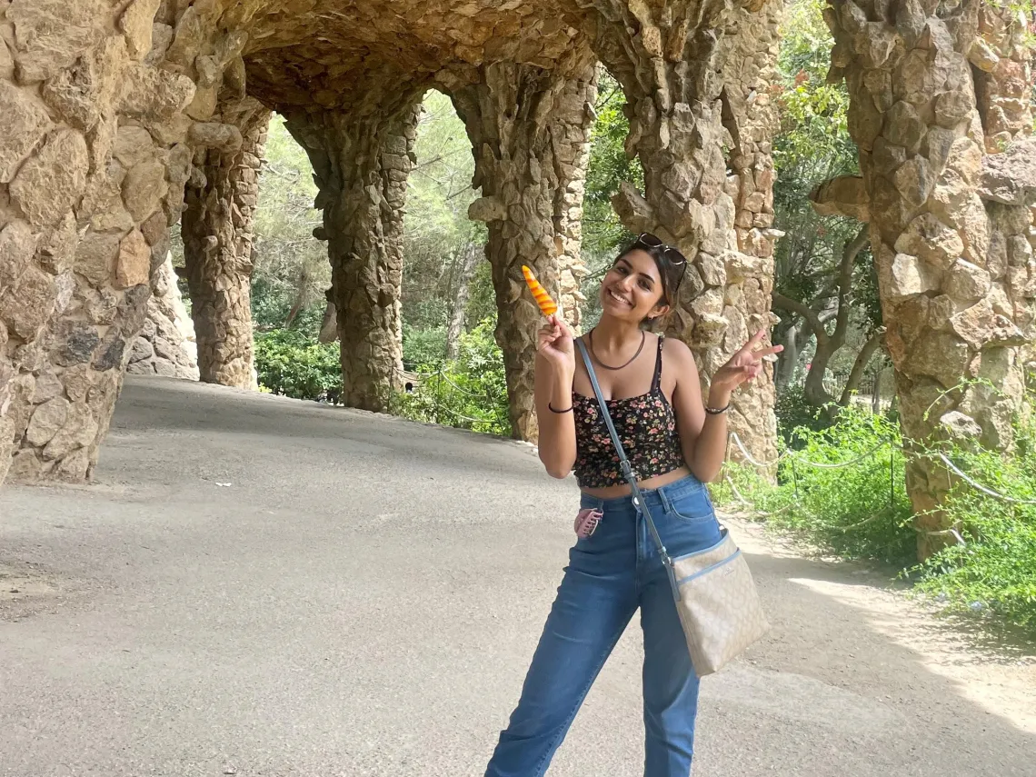 Grace Parekh in Spain under a stone building