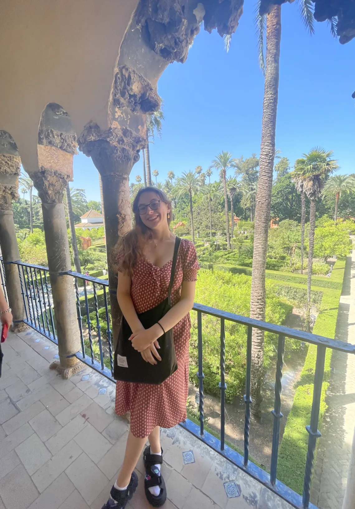 Olivia Seagraves in Spain smiling towards the camera, wearing a dress