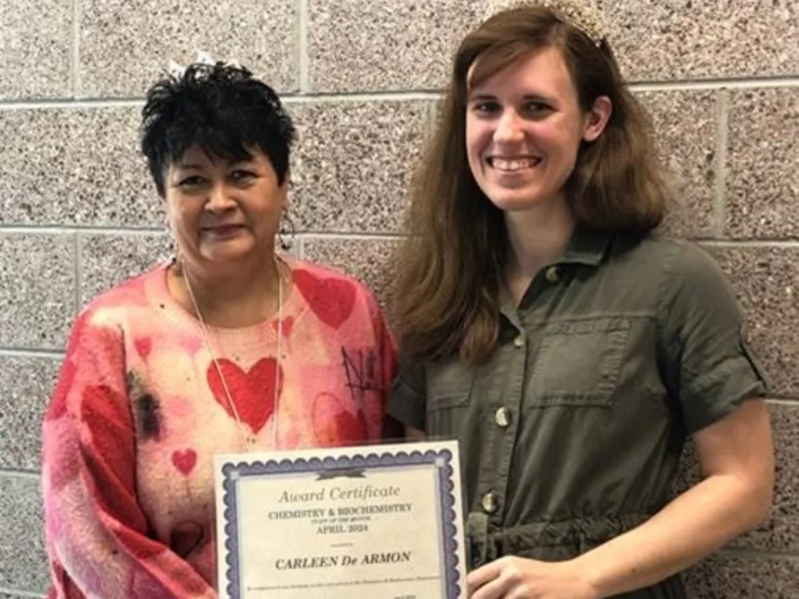 Carleen De Armon holding an award certificate