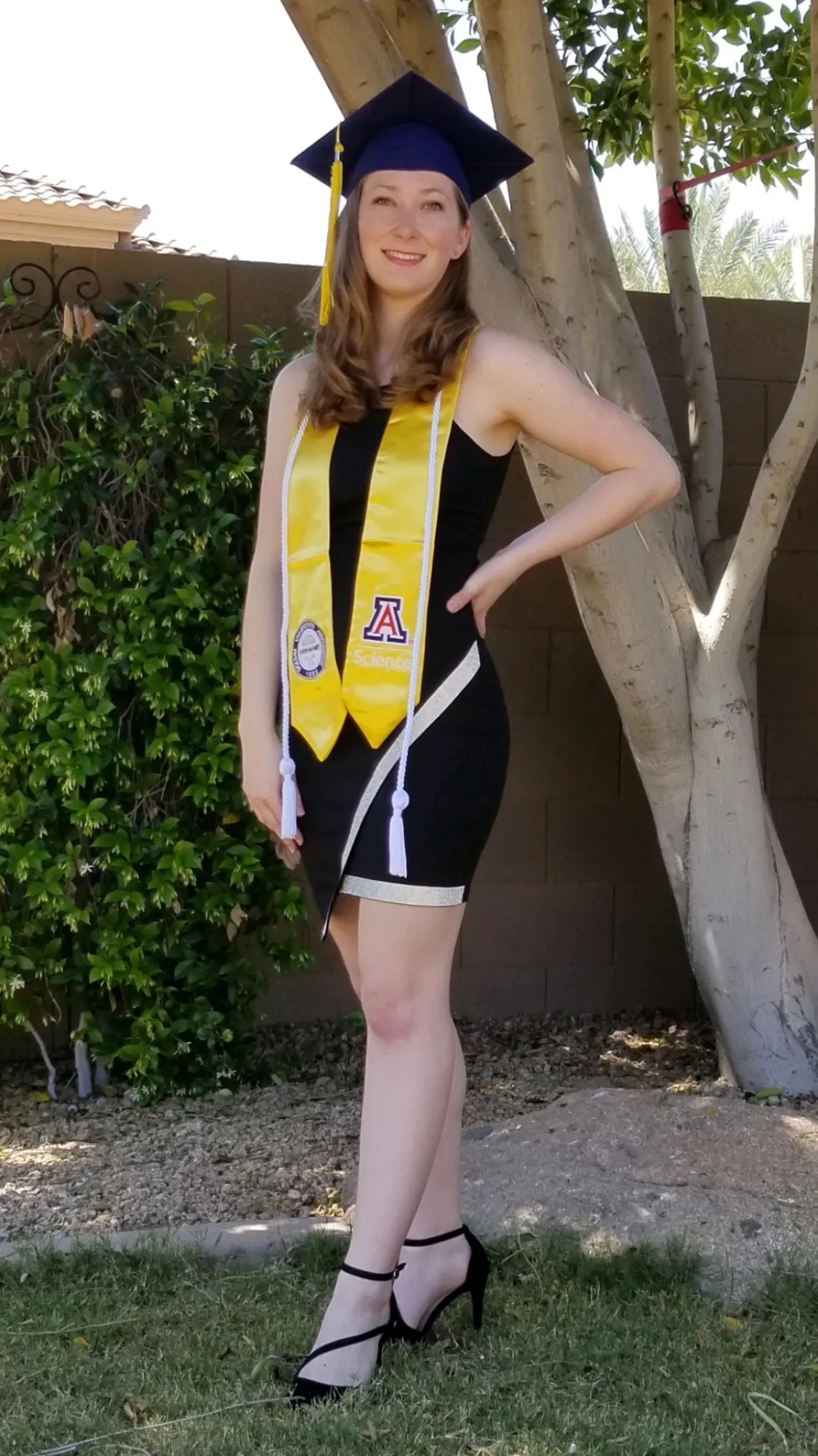 Photo of Ashley Wellington in graduation cap and gown