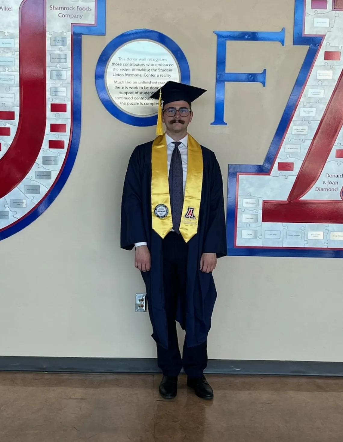 Michael Foster wearing a graduation cap and gown