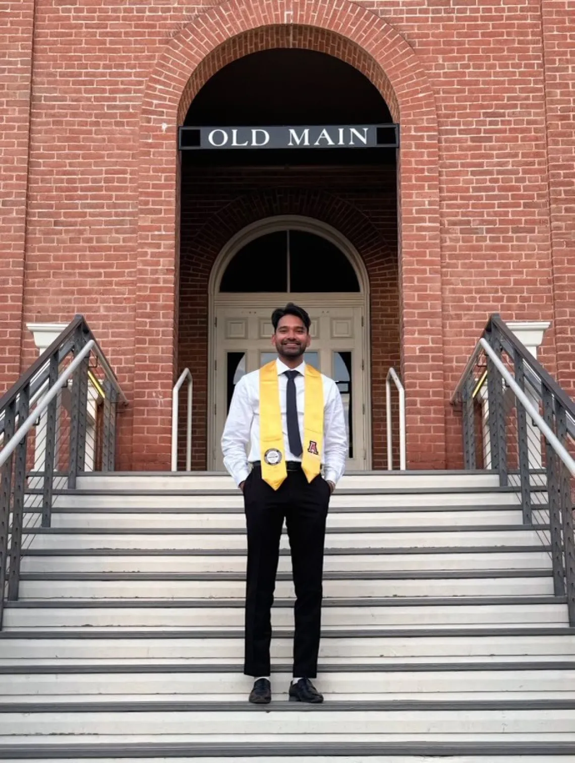 Neel Ahmed standing in front of University of Arizona Old Main Building