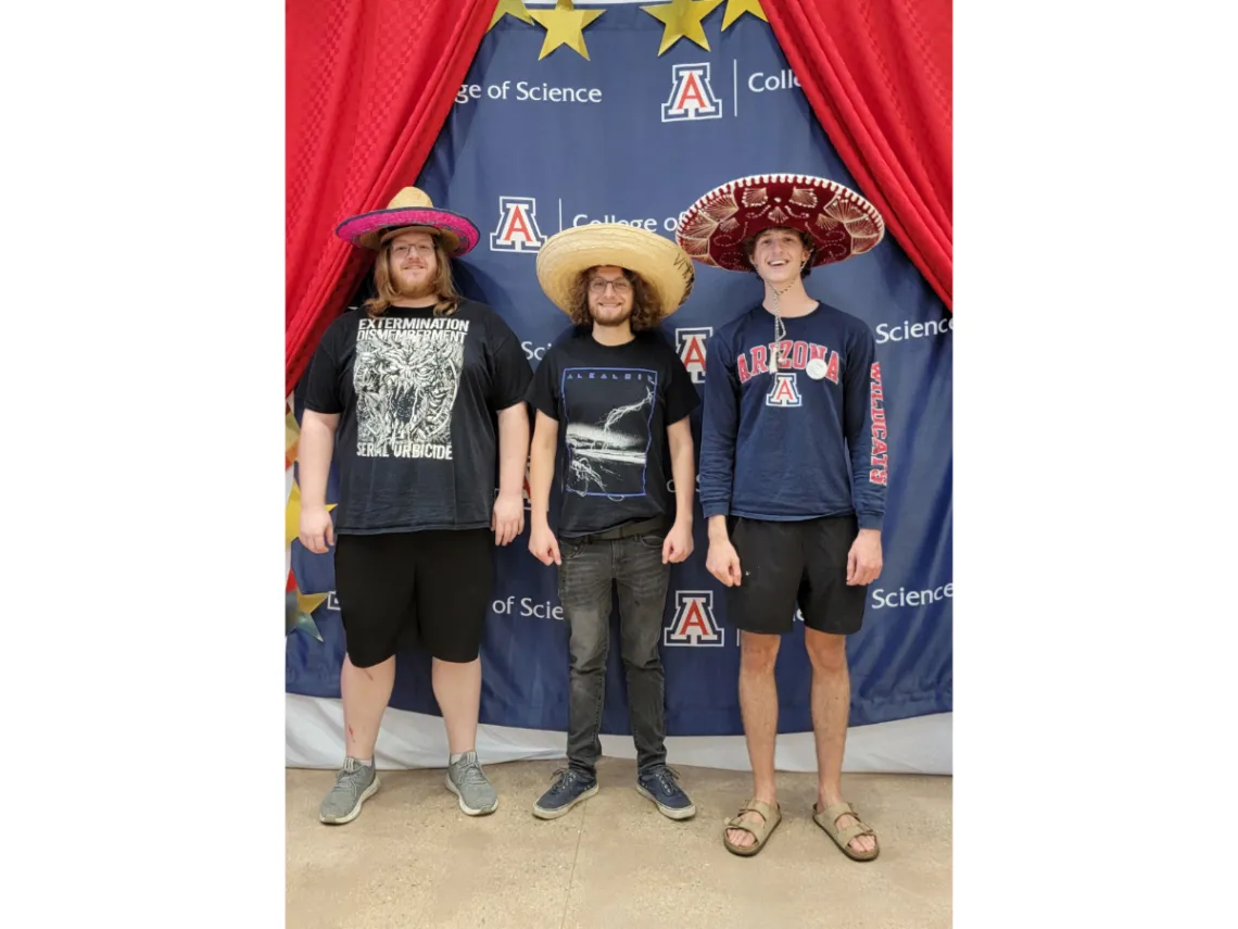 3 students wearing mariachi hats