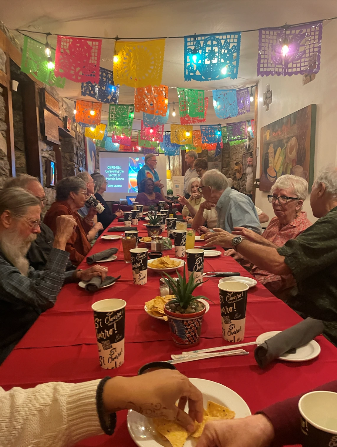 Dinner table with people on both sides of a rectangle table at Charro Cafe