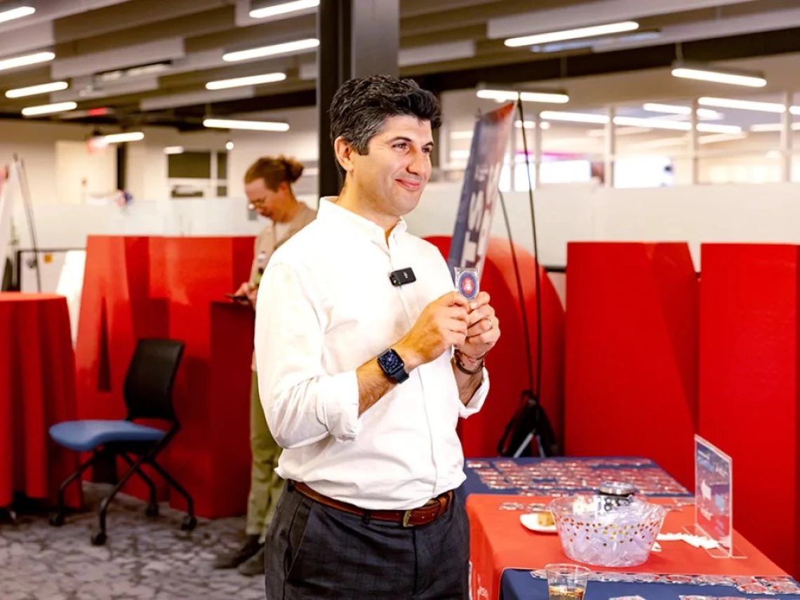 Iman Daryaei poses with his new patent coin.