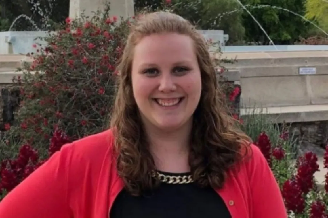 Holly Sofka smiling in front of old main water fountain