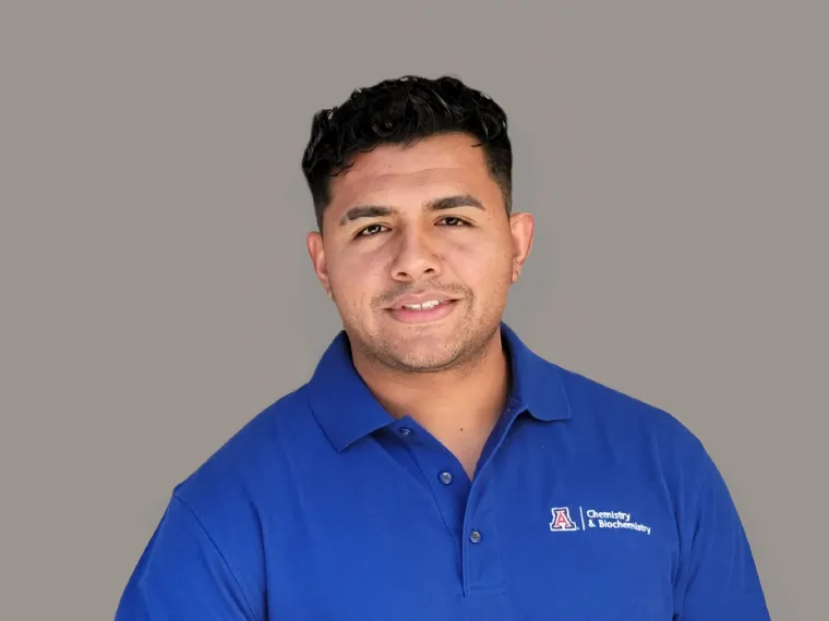 Hibram smiling in front of a grey background