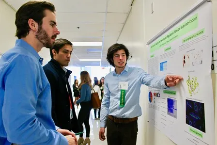 Student presenting a research poster