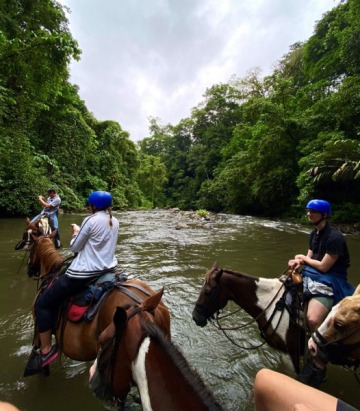 Horsing riding while crossing river