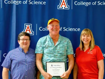 Awardee Scott Dreisbach holds award while standing between Department Head Craig Aspinwall and RSS Director Brooke Massani