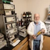 Photo of Dr. Robin Polt in lab holding a canister