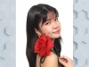 Amanda Nguyen holding a rose smiling towards the camera.